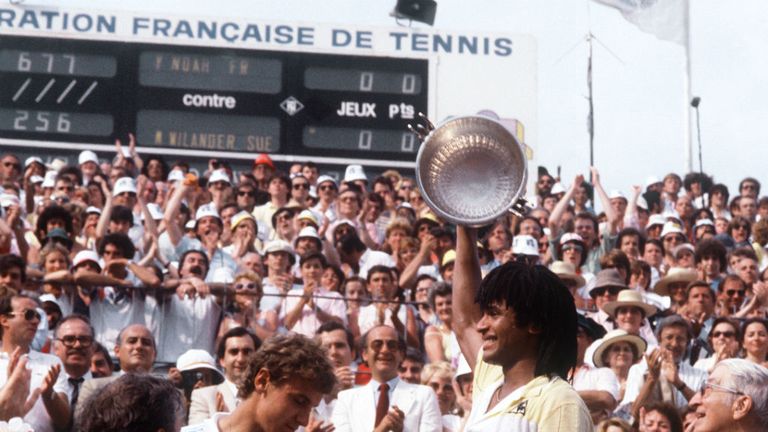 - French Yannick Noah R holds his trophy after beating Swedes Mats Wilander C and winning the French Tennis Open at the Roland Garros stadium in Paris 05 June 1983