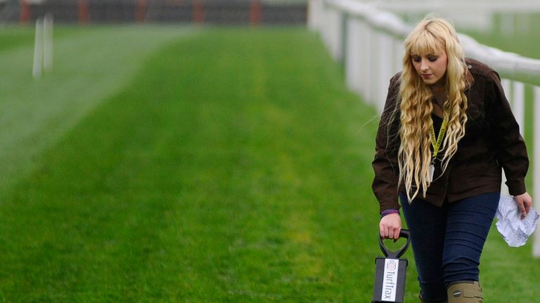 LIVERPOOL, ENGLAND - APRIL 03: The going on the hurdles track is checked with a going stick at Aintree racecourse on April 03, 2014 in Liverpool, England. 