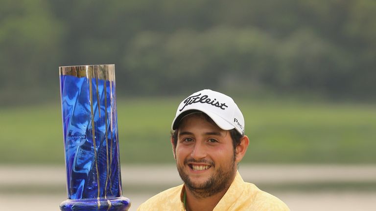 Alexander Levy of France celebrates with the trophy after winning the 2014 Volvo China Open