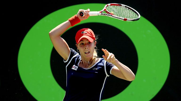 Alize Cornet returns a shot to Andrea Petkovic during the Sony Open at the Crandon Park Tennis Center