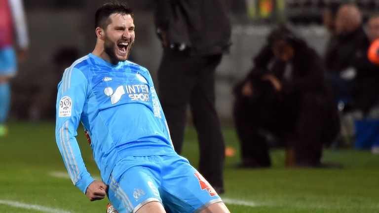 Marseille's French forward Andre-Pierre Gignac celebrates sliding on his knees after scoring a goal on April 11, 2014 at the Mosson stadium in Montpellier,