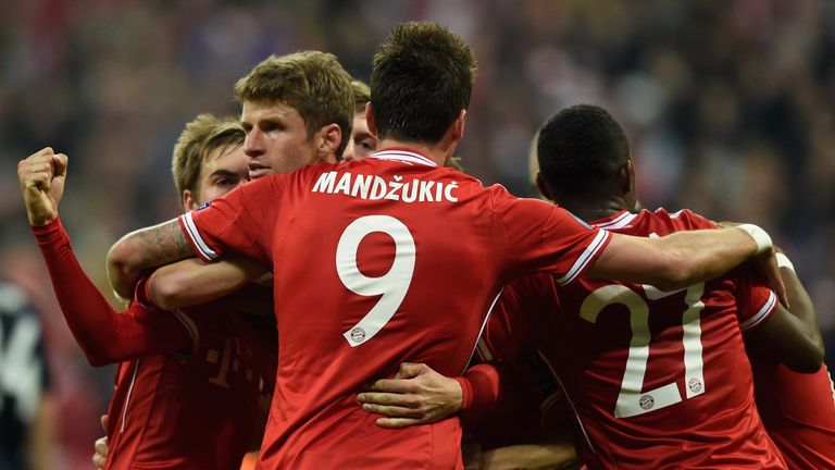 Bayern Munich's midfielder Thomas Mueller (2nd L) celebrates scoring the 2-1 goal with his teammates during the UEFA Champions League quarter-final second 