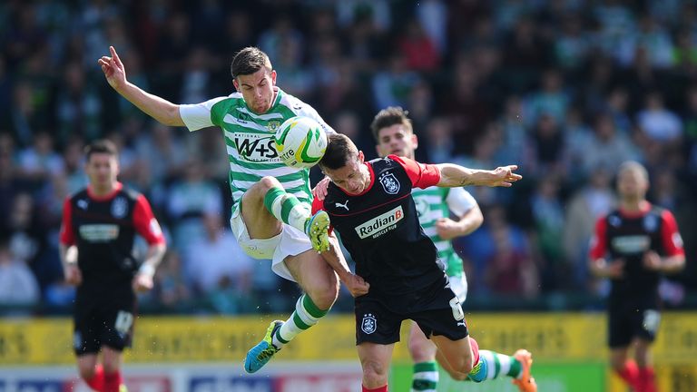 Kevin Dawson of Yeovil Town battles for the ball with Jonathan Hogg of Huddersfield Town