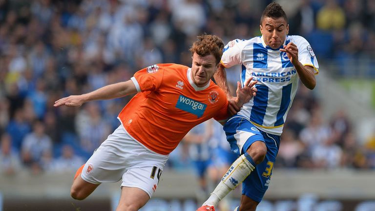 Andrew Halliday of Blackpool holds off a challenge from Jesse Lingard of Brighton during the Sky Bet Championship match