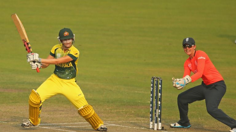 Jess Jonassen of Australia bats as Sarah Taylor of England looks on during the ICC Women's World Twenty20 final in Dhaka