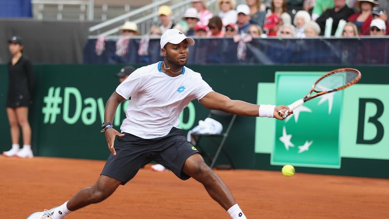 Donald Young of the United States stretches to play a forehand against Andy Murray of  Great Britain during day one of the Davis Cup