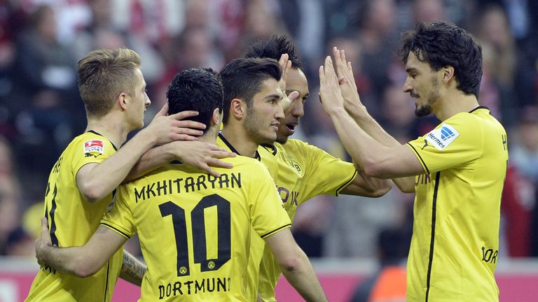 (L-R) Dortmund's midfielder Marco Reus, Dortmund's Armenian midfielder Henrikh Mkhitaryan, Dortmund's 