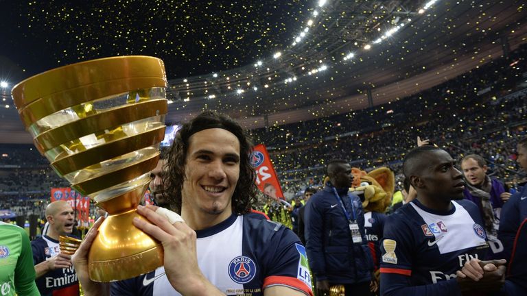 Paris' Uruguayan forward Edinson Cavani celebrates with the trophy after winning the French League Cup final football match between Paris Saint-Germain (PS