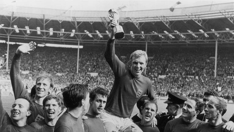 England captain Bobby Moore (1941 - 1993) holds up the Jules Rimet trophy as he is carried on the shoulders of his team-mates after their 4-2 victory over 