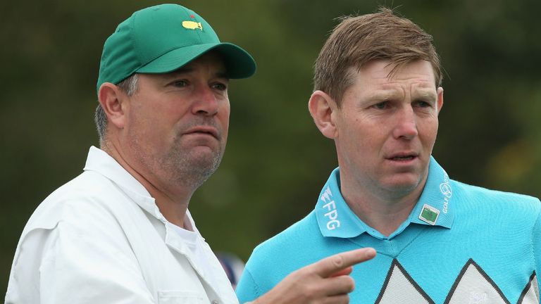 Stephen Gallacher of Scotland is pictured with his caddie Damian Moore during a practice round ahead of the 2014 Masters at Augusta National