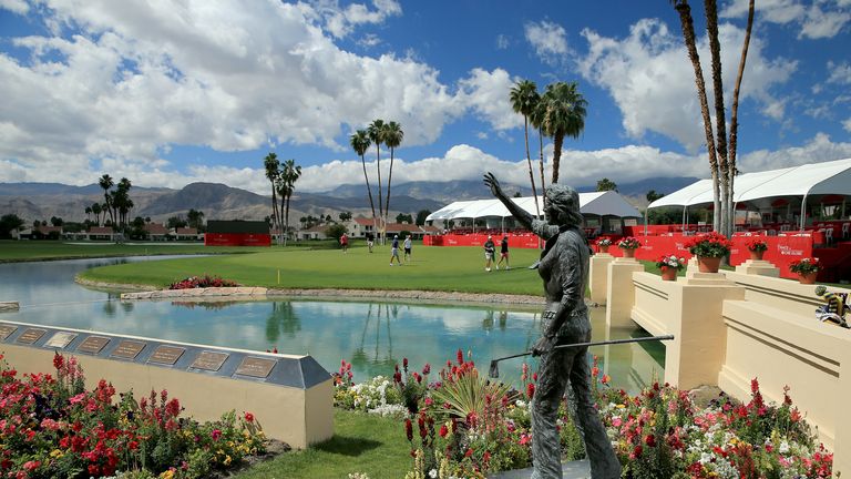 Players on the 18th green behind the statue of Dinah Shore who originated the event in 1972