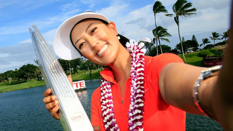 KAPOLEI, HI - APRIL 19:  Michelle Wie takes a selfie of herself with the trophy on the 18th green after winning the LPGA LOTTE Championship