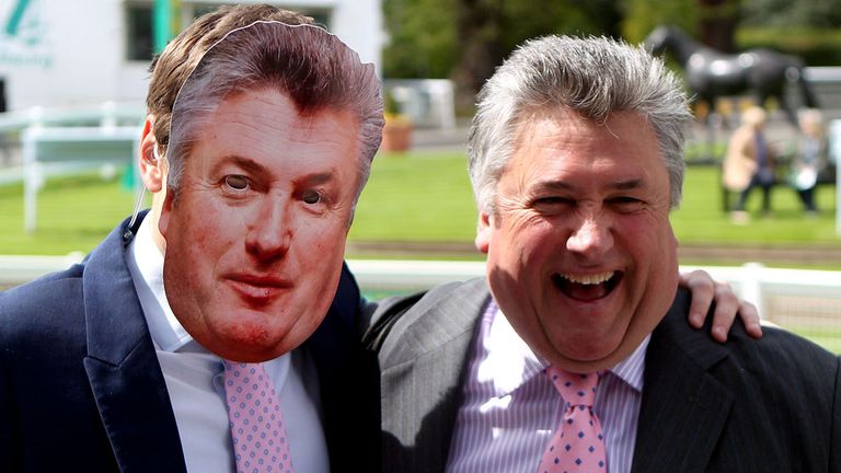 Paul Nicholls poses next to a face mask of himself  during the Bet365 Jump Finale at Sandown Park, Sandown. PRESS ASSOCIATION Photo. Picture date: Saturday