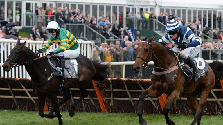 Whisper and Barry Geraghty (right) lead At Fishers Cross and Tony McCoy over the final hurdle as they go on to win the Silver Cross Stayers Hurdle Race dur