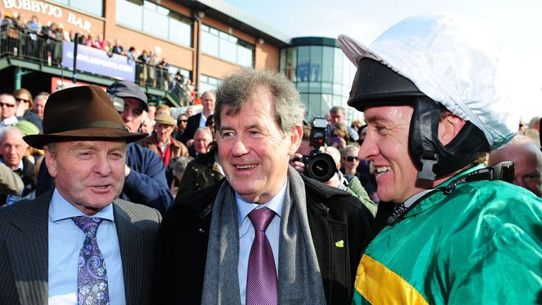 Trainer Jonjo O'Neill and owner JP McManus with jockey Barry Geraghty  after he rode Shutthefrontdoor to victory in the Boylesports Irish Grand National St