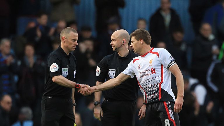 Liverpool's Steven Gerrard (right) shakes hands with assistant referee Stuart Burt   