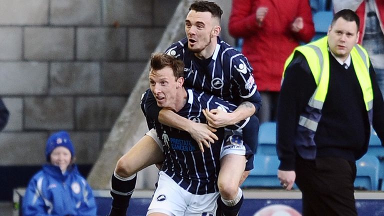 Millwall's Martyn Woolford celebrates his goal with team mate Shaun Williams (top) during the Sky Bet Championship match at The New Den, London.