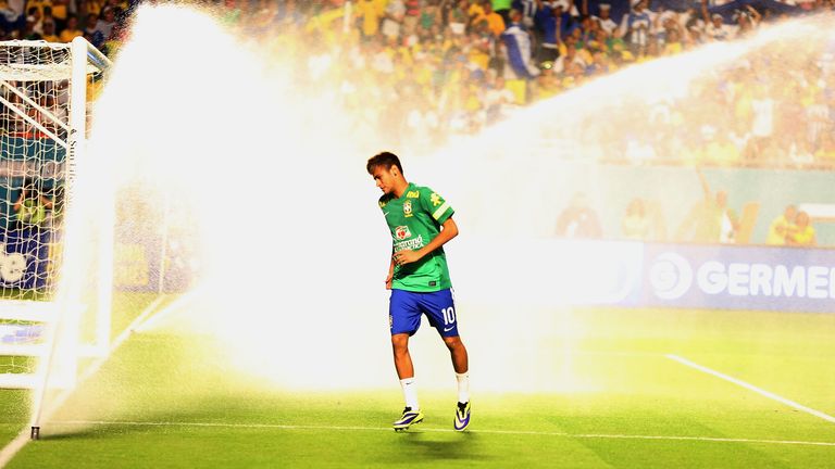 Neymar #10 of Brazil gets caught in the sprinklers prior to playing a friendly between Brazil and Honduras at Sun Life St