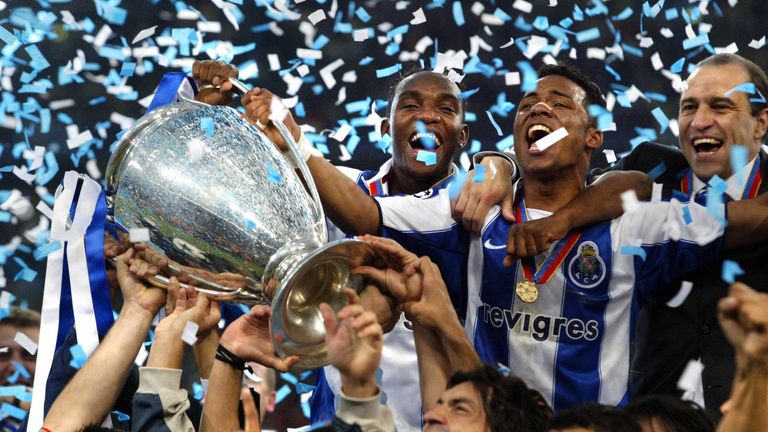 FC Porto's Benni McCarthy and Carlos Alberto hold the trophy as they celebrate with their teamates after beating Monaco in 2004 Champions League final