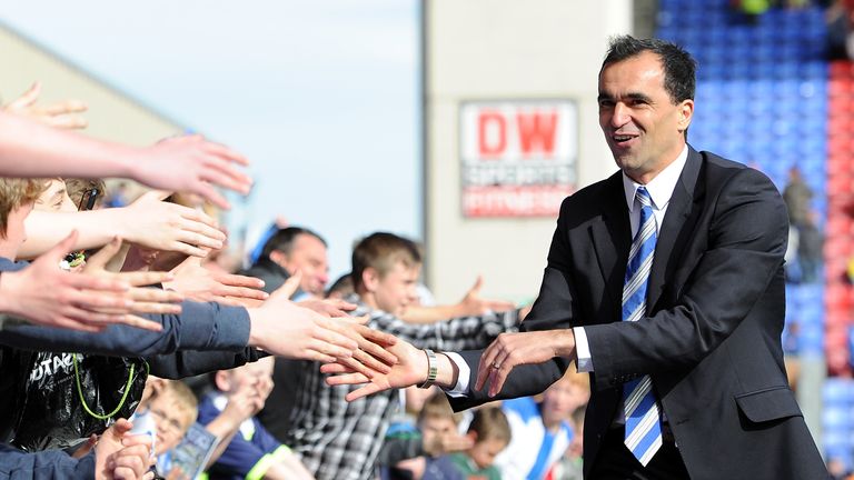 Wigan Athletic manager Roberto Martinez celebrates after avoiding relegation from the Barclays Premier League