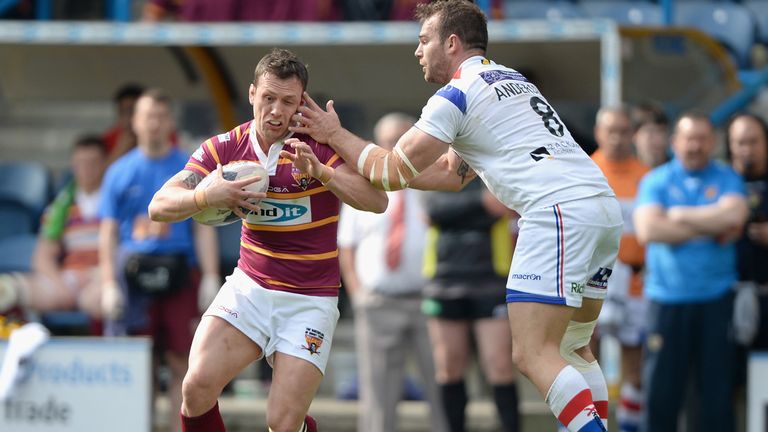 HUDDERSFIELD, ENGLAND - APRIL 21:  Shaun Lunt of Huddersfield Giants gets past Scott Anderson of Wakefield Trinity Wildcats during the Super League match b