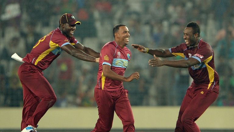 West Indies bowler Samuel Badree (C) celebrates with captain Darren Sammy (L) and Andre Russell