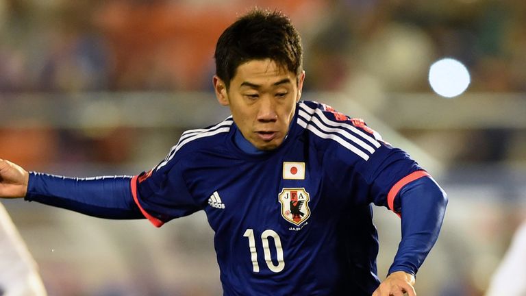 Japan's forward Shinji Kagawa shoots the ball in the penalty kick during their international friendly football match against New Zealand