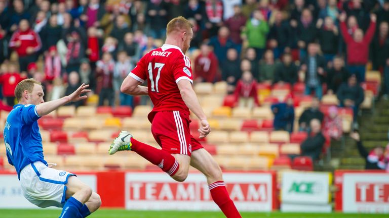 Adam Rooney (centre) prods the ball into the net after rounding keeper Alan Mannus to equalise for Aberdeen
