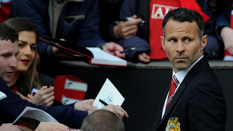 Manchester United's interim manager Ryan Giggs signs autographs before the Barclays Premier League match at Old Trafford, Manchester.