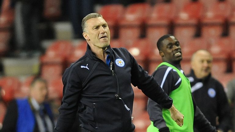 Leicester City's Manager Nigel Pearson celebrates with the traveling fans after the game against Wigan Athletic