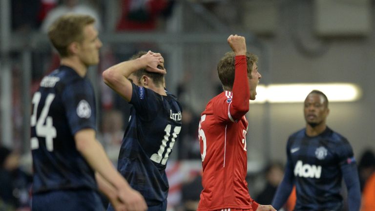 Bayern Munich's midfielder Thomas Mueller (C) reacts after scoring a goal during the UEFA Champions League quarter-final second leg football match Bayern M