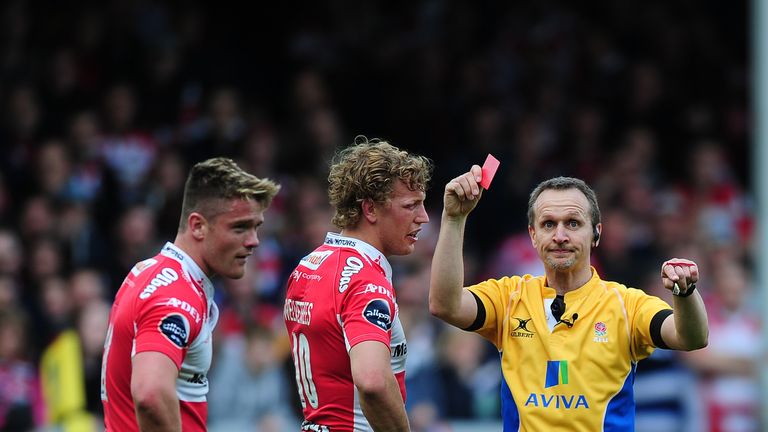 Tavis Knoyle of Gloucester (L) receives a red card from referee Tim Wigglesworth