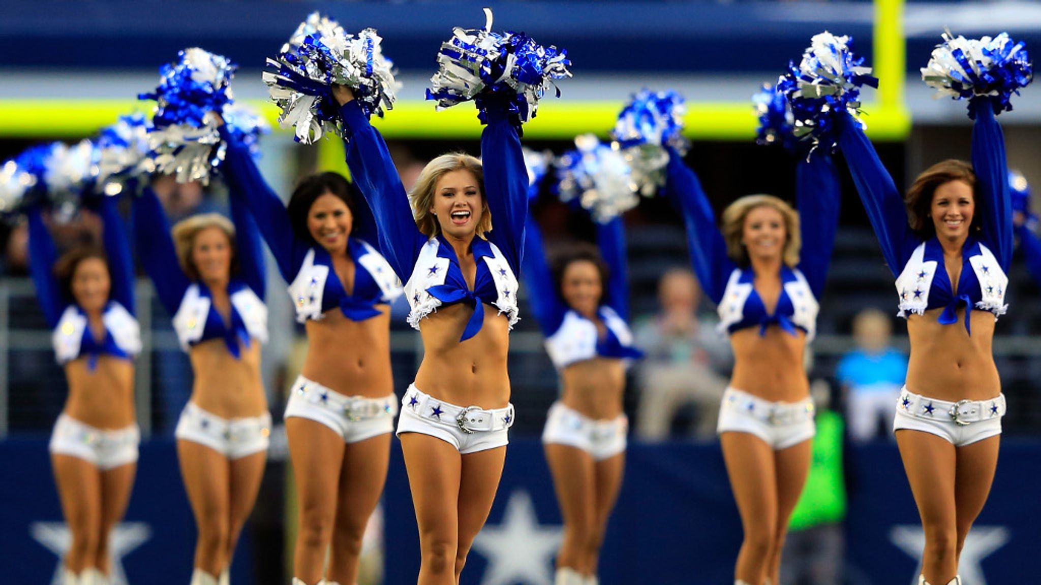 This Dallas Cowboys Cheerleader, Angela (the team does not publicize the  last names of its cheerleading squad members), and about 35 others,  entertain the crowd at a National Football League game at