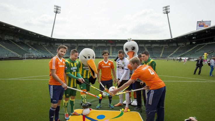 The Hague's players and Dutch hockey internationals pose along with their mascots at the Kyocera stadium in The Hague