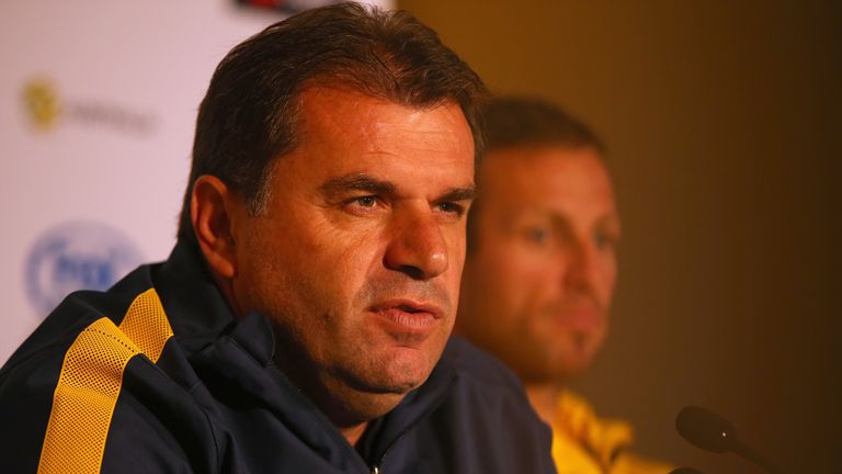 Socceroos manager Ange Postecoglou speaks to the media at an Australia press conference with Lucas Neill in the background