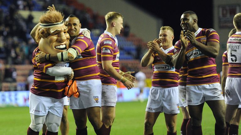 Huddersfield prop Antonio Kaufusi celebrates with the mascot after the team's victory during the First Utility Super League match