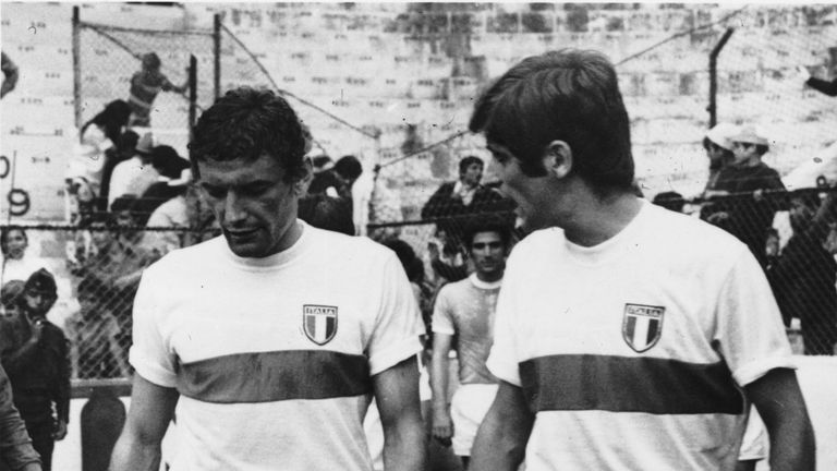 Italian strikers Luigi Riva and Gianni Rivera walk onto the pitch before their World Cup match against Israel in Mexico.  