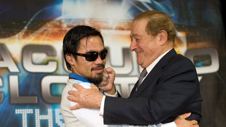 Boxing promoter Bob Arum (R) hugs boxer Manny Pacquiao of the Philippines (L) following the latter's victory over Joshua Clottey