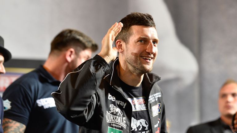 Carl Froch puts a hand to his ear at a the weigh-in for his rematch with George Groves.
