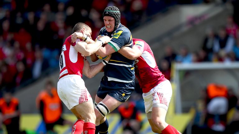 Chris Jones of Worcester is tackled by Gordon Ross (L) and Rob Lewis (R) of London Welsh
