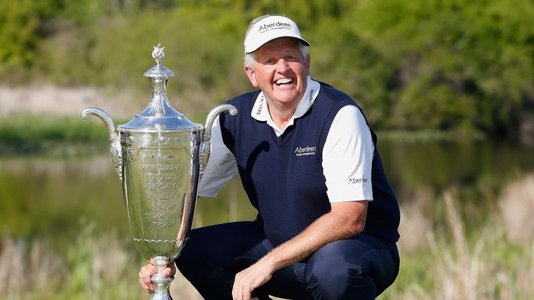 BENTON HARBOR, MI - MAY 25: Colin Montgomerie of Scotland poses with the Alfred S. Bourne Trophy after winning the 2014 Senior PGA Championship presented b