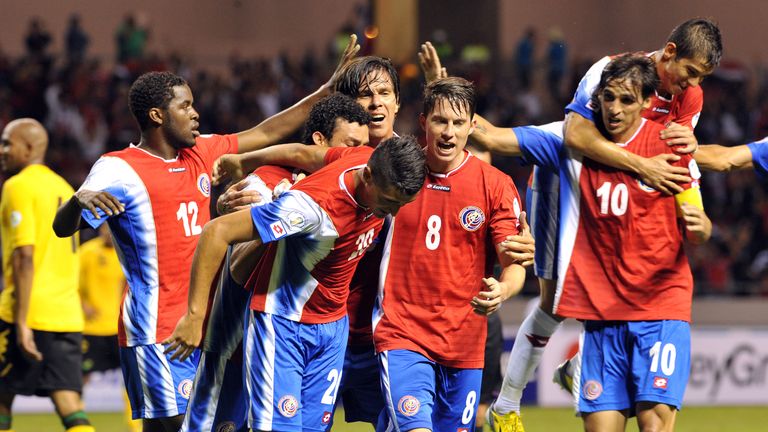Costa Rican players celebrate their second goal against Jamaica during their World Cup qualifier