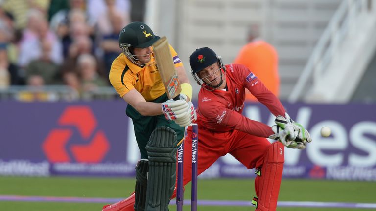 Riki Wessels of Nottinghamshire Outlaws guides a shot past Jos Buttler of Lancashire Lightning during the NatWest T20 Blast