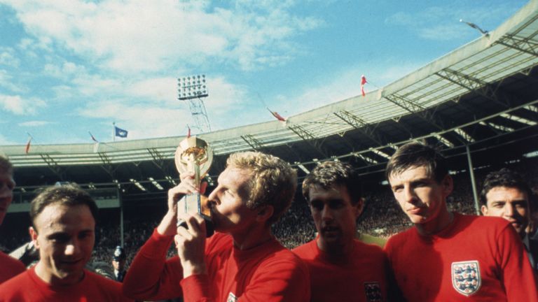 England captain Bobby Moore kissing the Jules Rimet trophy as the team celebrate winning the 1966 World Cup final against Germany at Wembley Stadium. His t