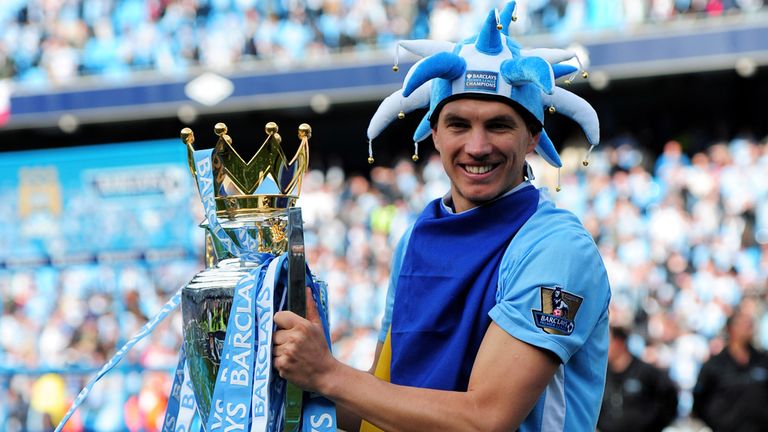 Edin Dzeko of Manchester City poses with the Premier League trophy in 2012