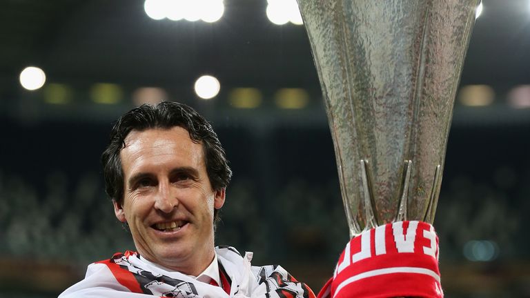 TURIN, ITALY - MAY 14:  Head Coach Unai Emery of Sevilla celebrates with the Europa league trophy during the UEFA Europa League Final match between Sevilla