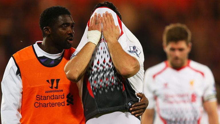 Kolo Toure of Liverpool consoles the dejected Luis Suarez 
