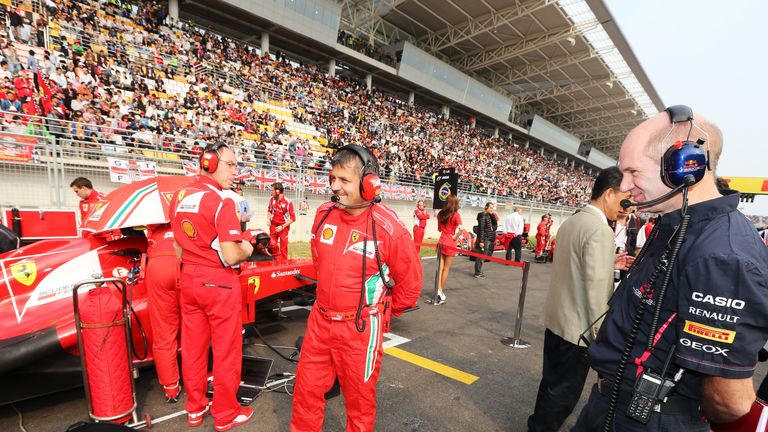 Adrian Newey looks at a Ferrari on the grid