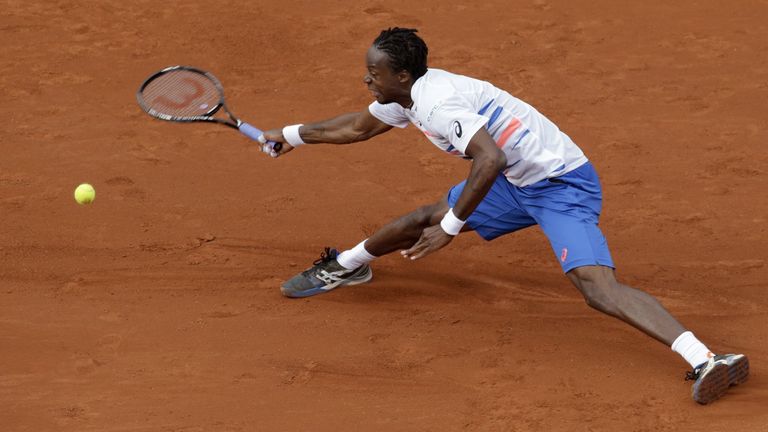 Gael Monfils returns to Victor Hanescu during their French Open first round match