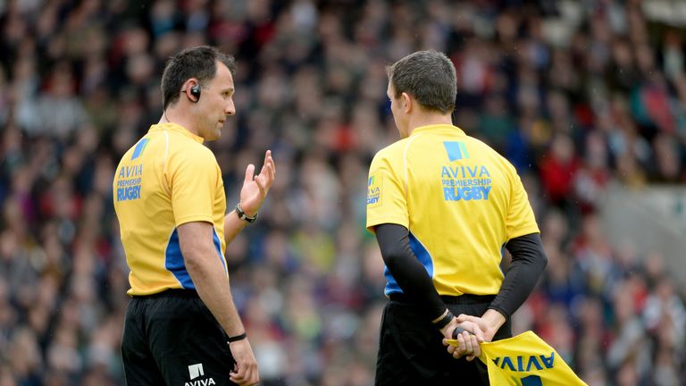Referee Greg Garner talks to his assistant prior to sending off Justin Melck of Saracens during the Aviva Premiership match. May 10 2014.